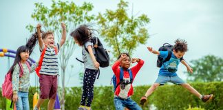 kids preschool kindergarten enjoy and happy jumping on the field of playground after school class is over to returning home